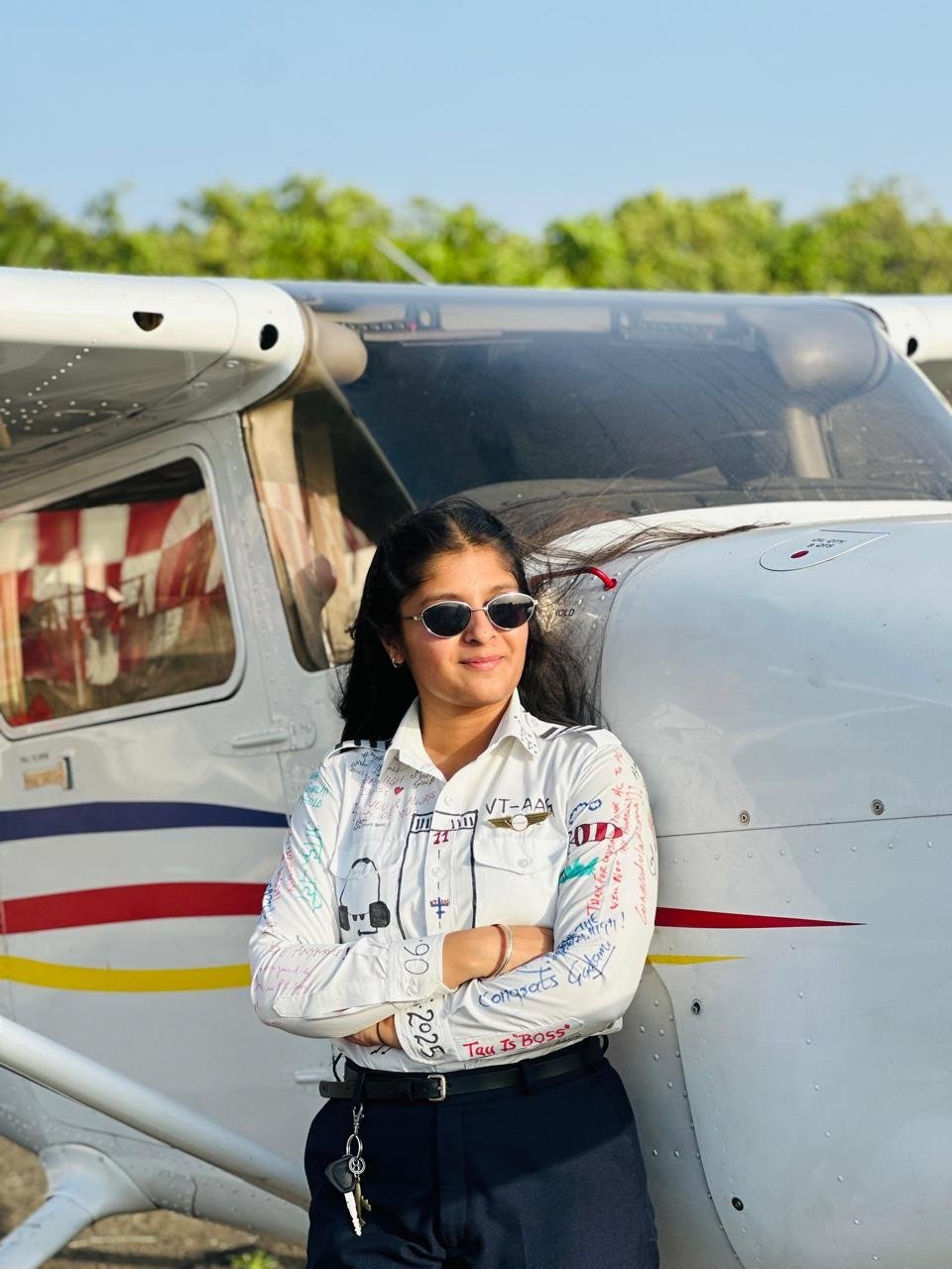 Aviation student beside a training aircraft on first solo day